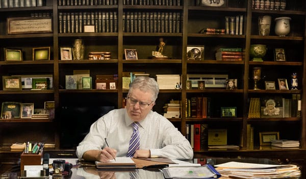 Photo of attorney Ryan Hill working at his desk